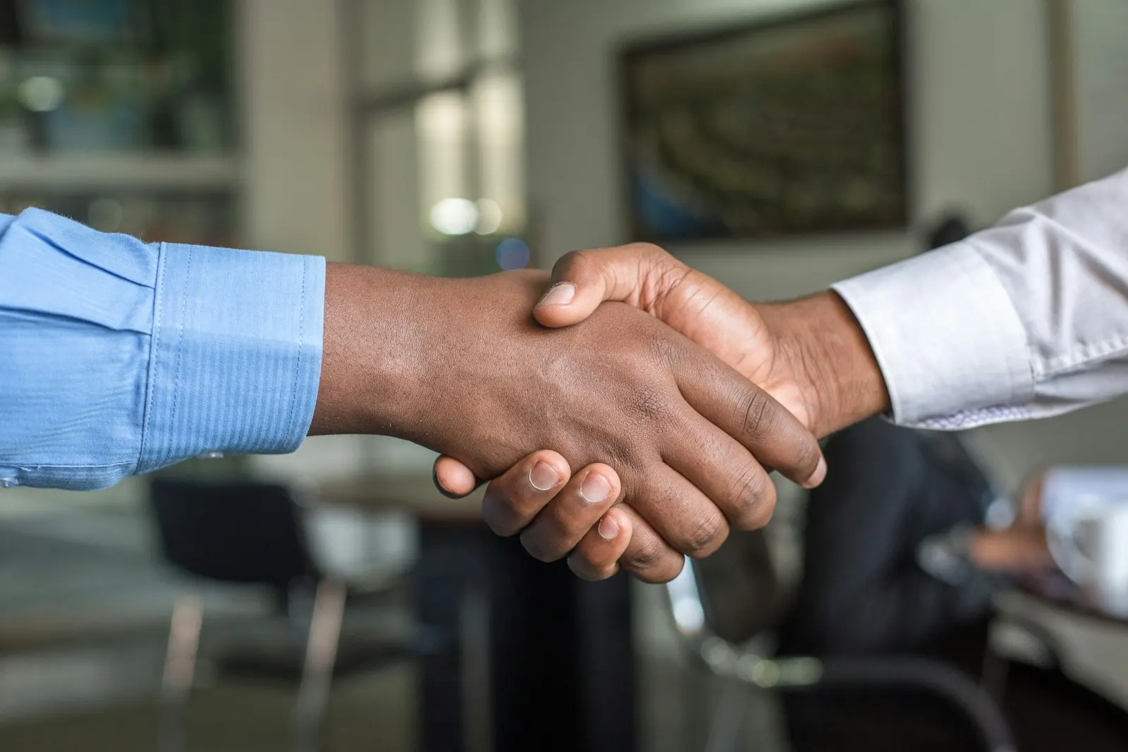 Handshake between two partners in an office