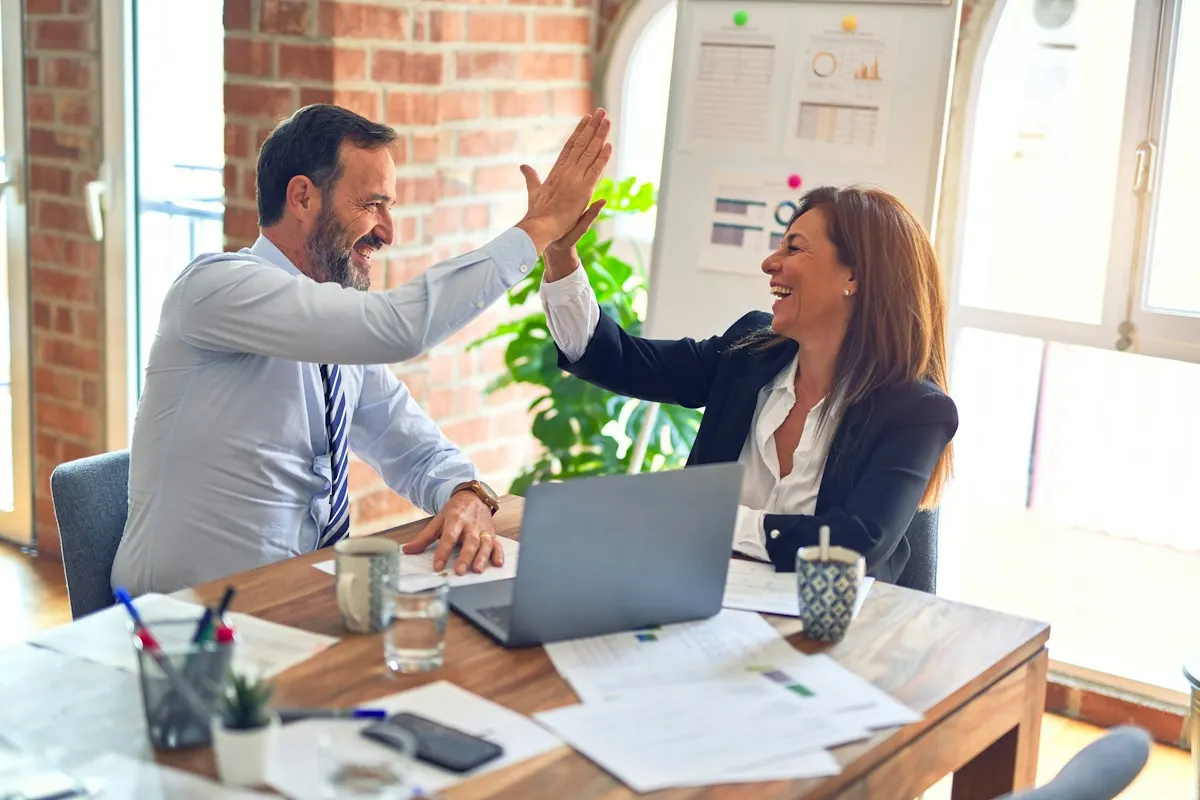Two colleagues celebrating after a working session